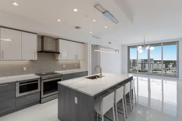 a kitchen with granite countertop a stove and a sink