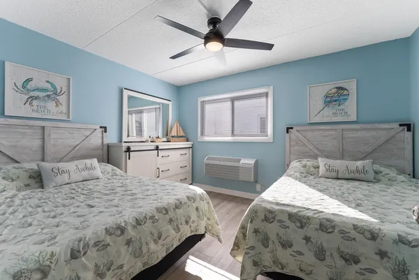 a bedroom with a large bed and a chandelier