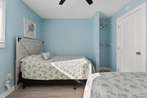 a bedroom with a bed and wooden floor
