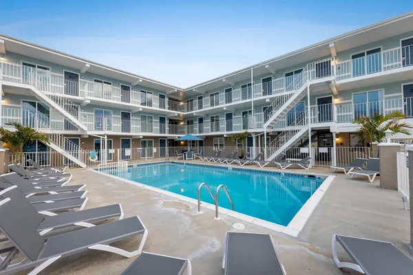 a swimming pool view with a outdoor seating