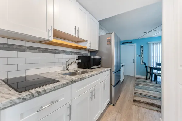a spacious bathroom with a granite countertop sink and a mirror