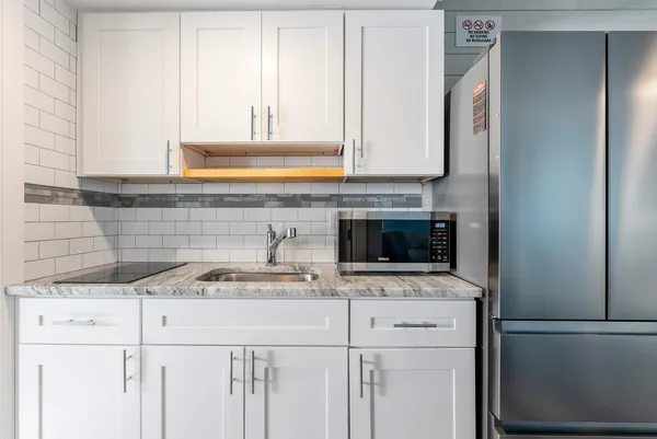 a kitchen with a sink and a refrigerator