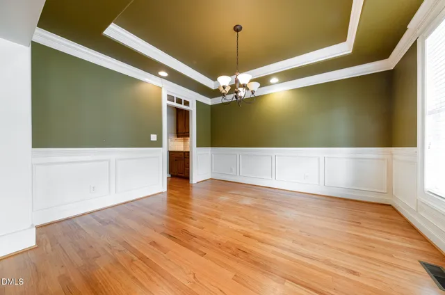 a view of a livingroom with a ceiling fan and wooden floor