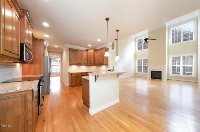 a view of kitchen with kitchen island and stainless steel appliances