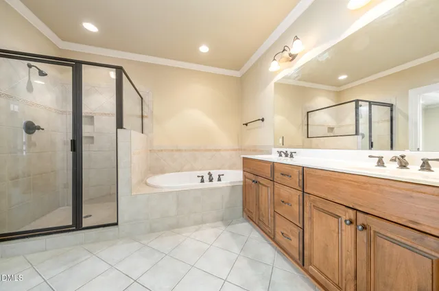 a spacious bathroom with a double vanity sink mirror and shower