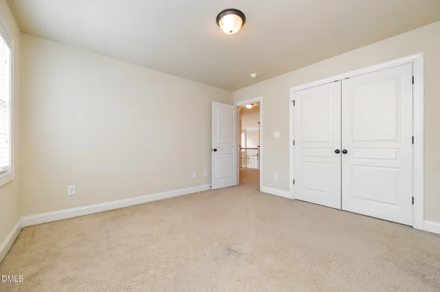 an empty room with closet area