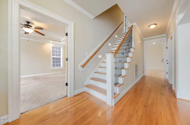 a view of entryway with wooden floor and stairs