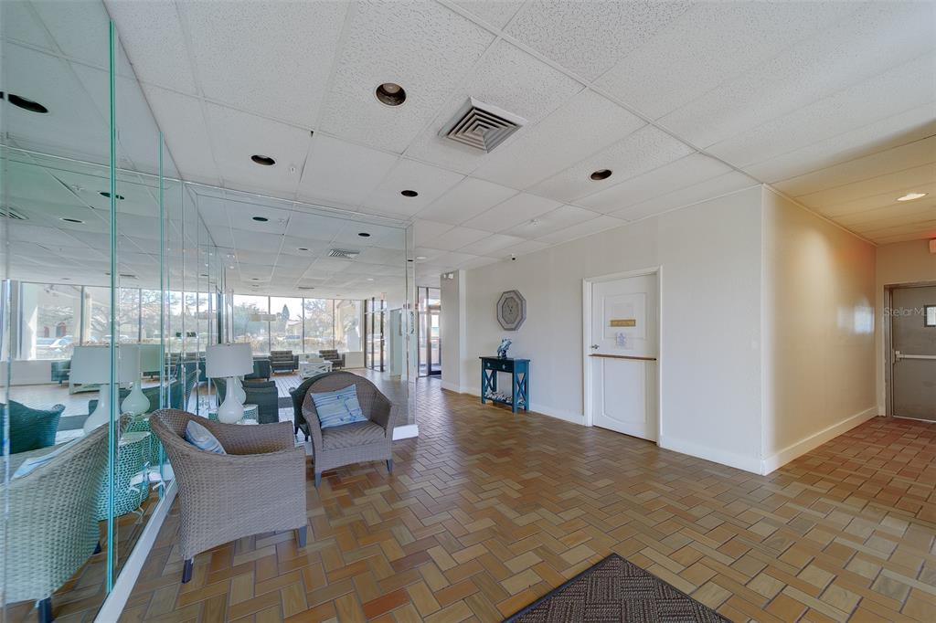 255 Dolphin Point, Unit 802 Clearwater Beach, FL 33767 - Photo 37 of 41 a living room with furniture and a large window