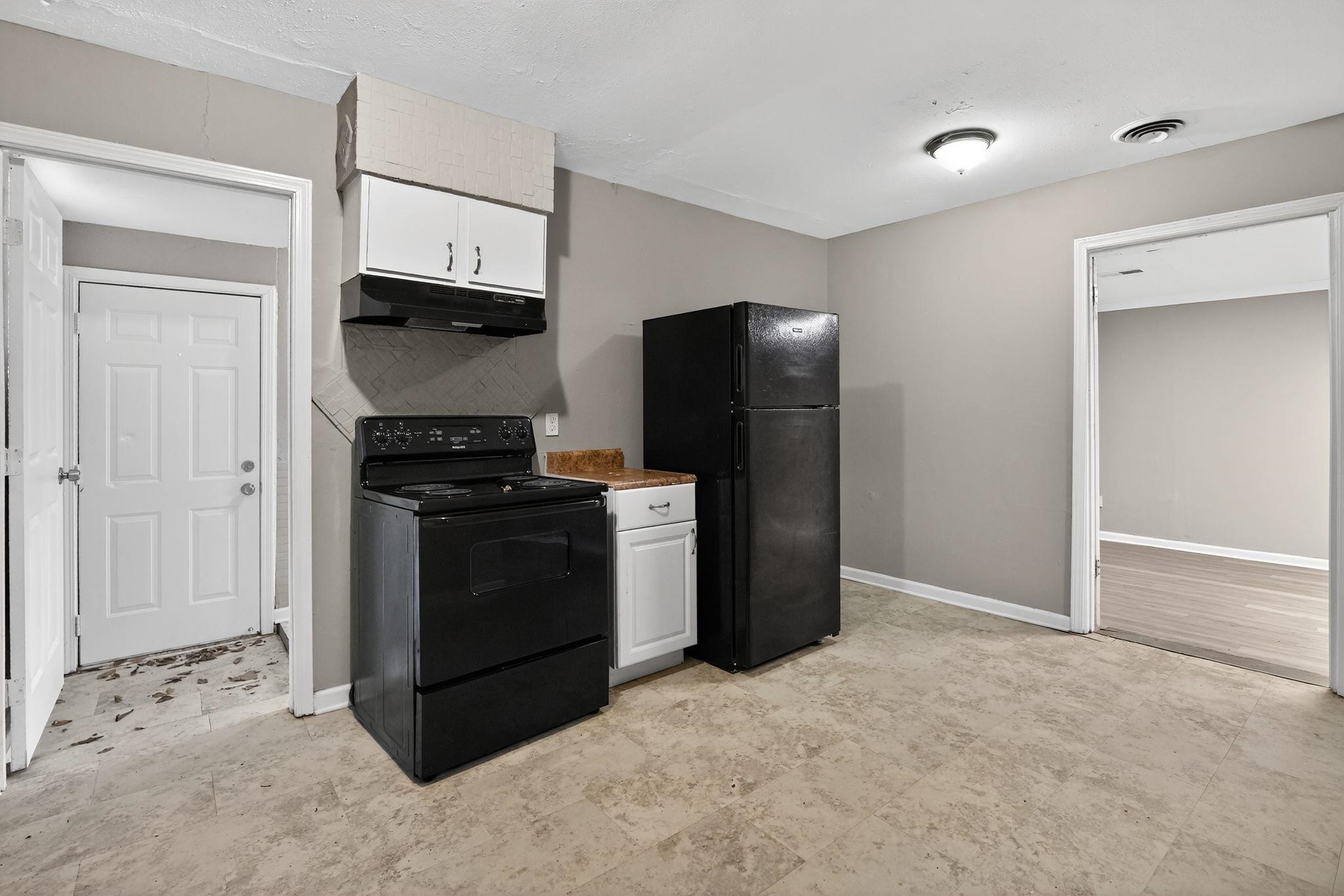 3981 Maynard Drive Memphis, TN 38109 - Photo 11 of 31 a kitchen with stainless steel appliances a refrigerator and a stove top oven