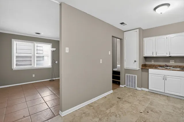 a kitchen with granite countertop white cabinets and appliances
