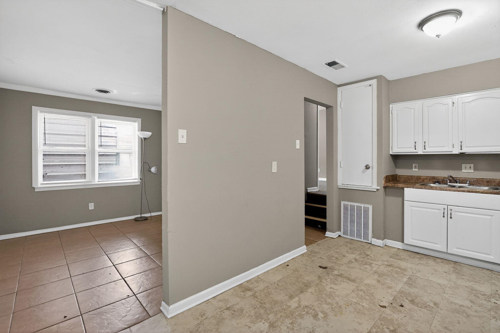 3981 Maynard Drive Memphis, TN 38109 - Photo 13 of 31 a kitchen with granite countertop white cabinets and appliances