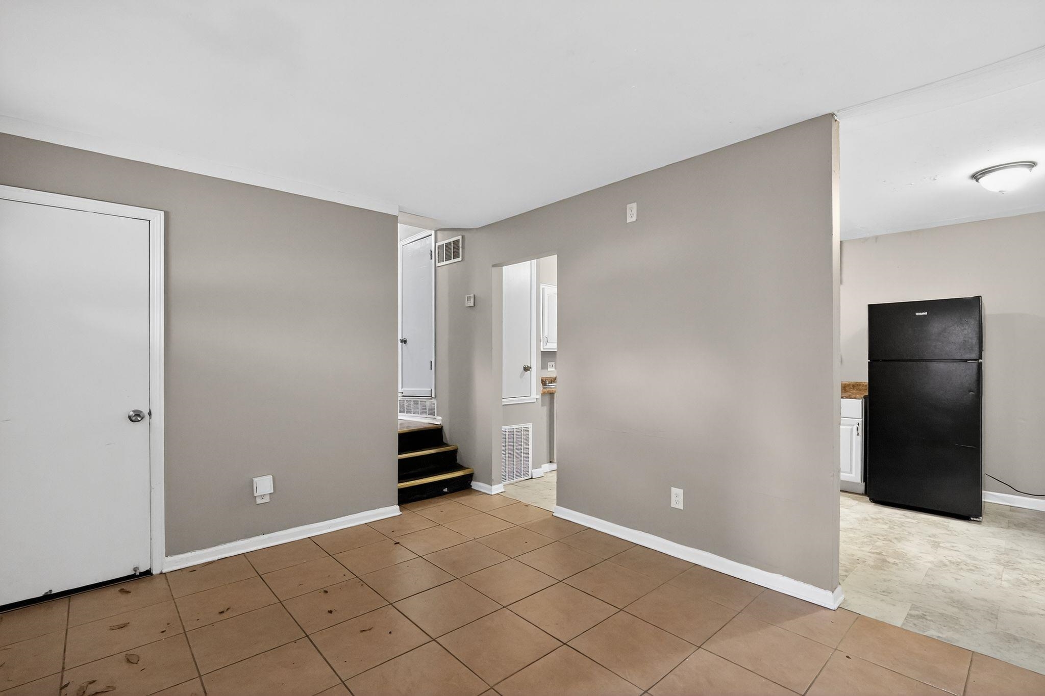 3981 Maynard Drive Memphis, TN 38109 - Photo 18 of 31 Unfurnished bedroom with freestanding refrigerator and light tile patterned flooring