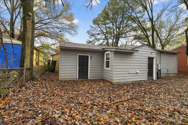 a backyard of a house with large trees
