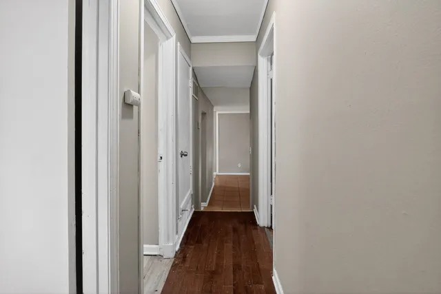 a view of a hallway with a wooden floor