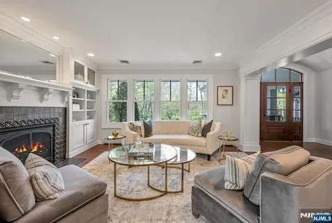 a view of a dining room with furniture chandelier and wooden floor