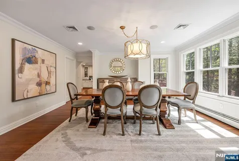 a living room with furniture fireplace and a large window