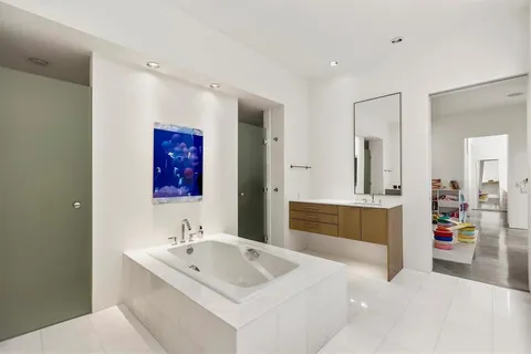 a bathroom with a sink toilet vanity and shower