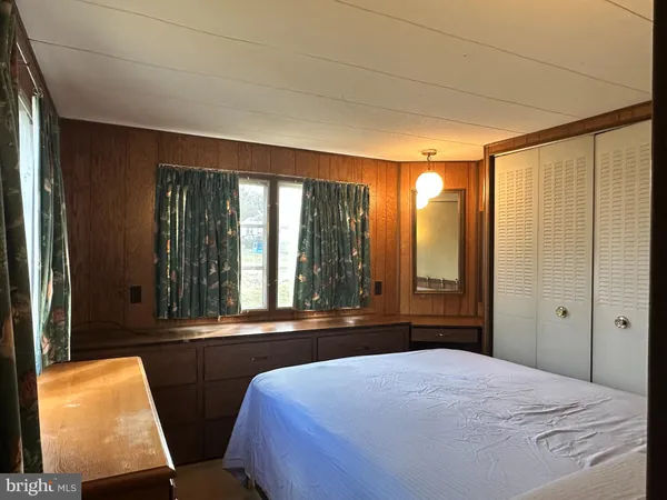 a bedroom with a bed and a mirror