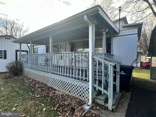 a view of a house with a small yard and wooden fence