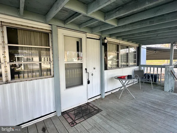 a work room with wooden furniture and windows