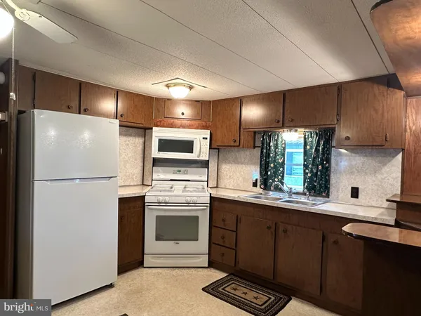 a kitchen with stainless steel appliances a refrigerator stove and sink