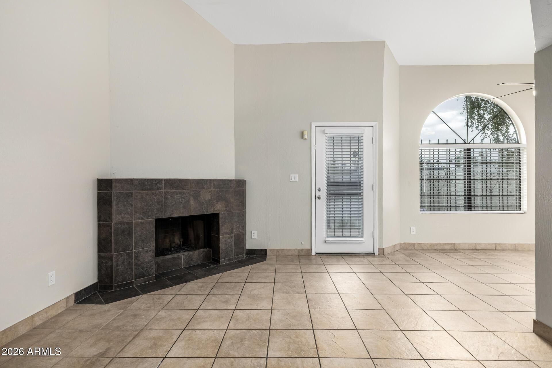 4328 North 36th Street, Unit 3 Phoenix, AZ 85018 - Photo 6 of 28 a view of an empty room with a fireplace and a window