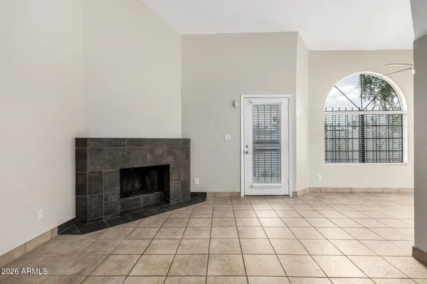 a view of an empty room with a fireplace and a window