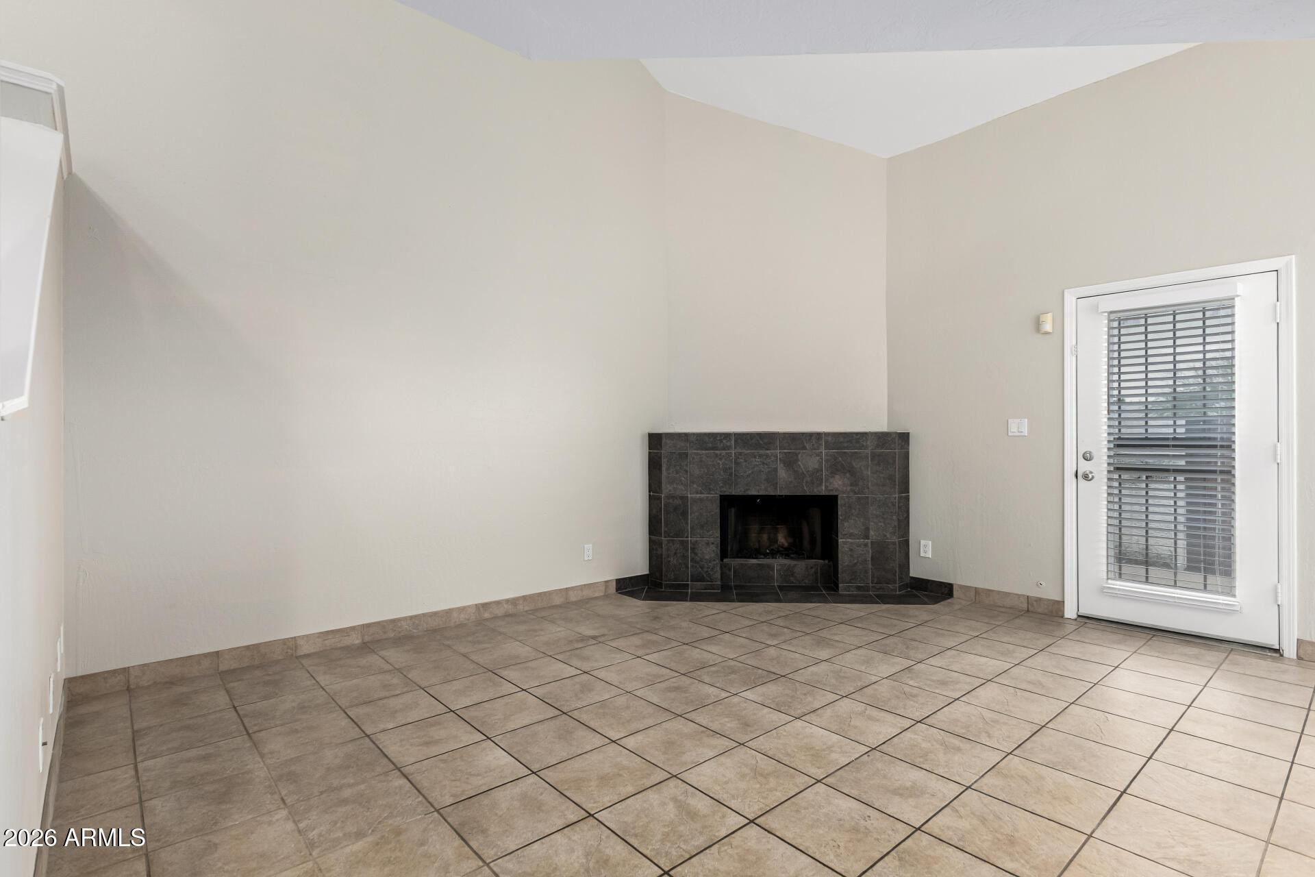 4328 North 36th Street, Unit 3 Phoenix, AZ 85018 - Photo 7 of 28 a view of an empty room with a fireplace and a window