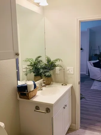 a view of bathroom with a sink and mirror