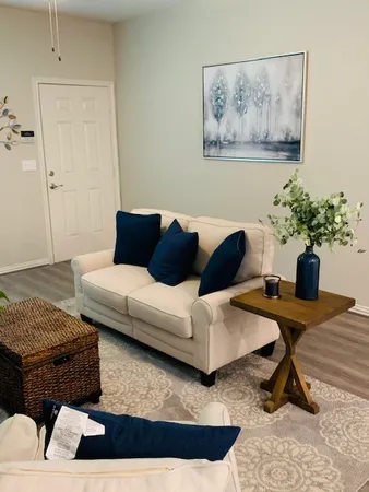 a living room with furniture and a potted plant