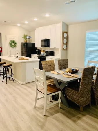 a kitchen with a dining table and chairs