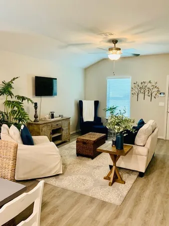 a living room with furniture and a flat screen tv