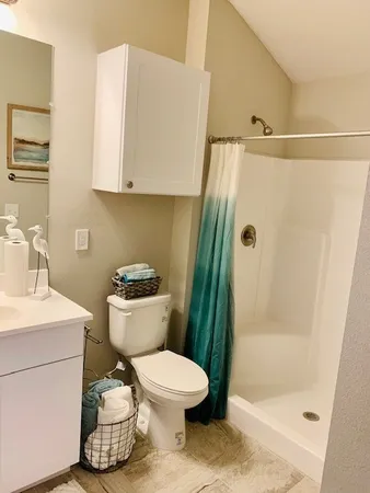 a bathroom with a toilet and a shower