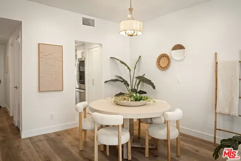 a dining room with furniture a rug and a chandelier