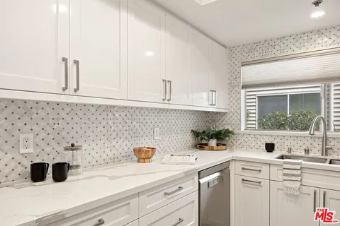 a kitchen with a refrigerator and a sink