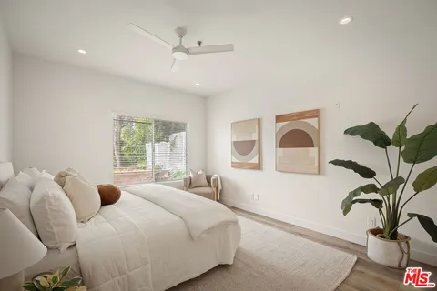 a bedroom with a bed and glass window
