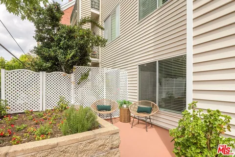 a view of a chairs and table in the patio