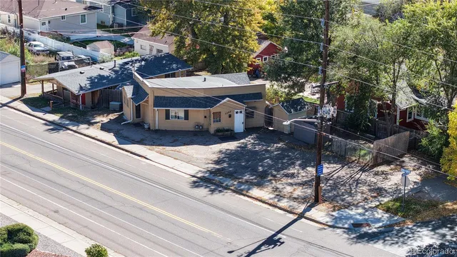 a view of a house with a yard and sitting area