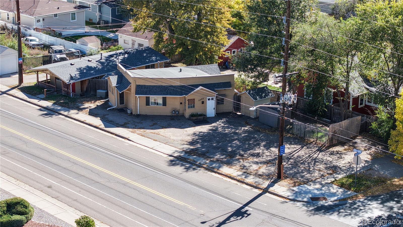 a view of a house with a yard and sitting area