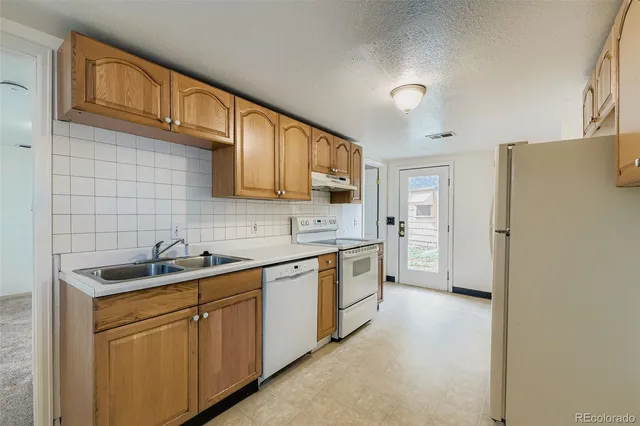 an empty room with a bathroom and a sink