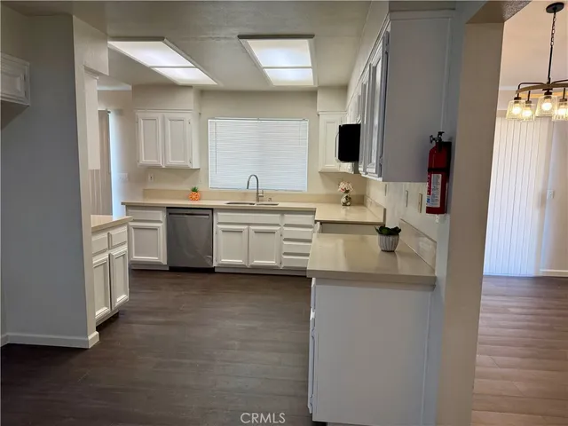 a kitchen with stainless steel appliances a sink dishwasher stove refrigerator and microwave