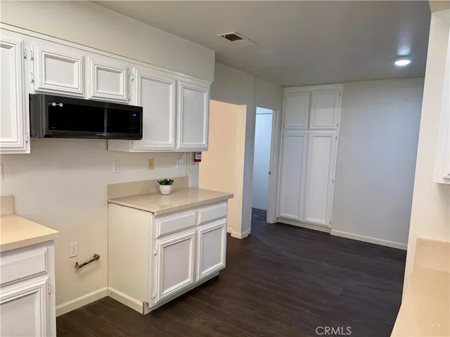 a kitchen with cabinets and steel appliances