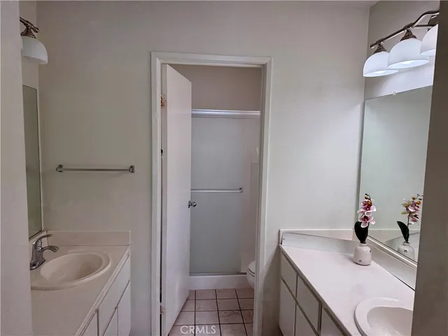 a bathroom with a sink vanity granite tub and shower