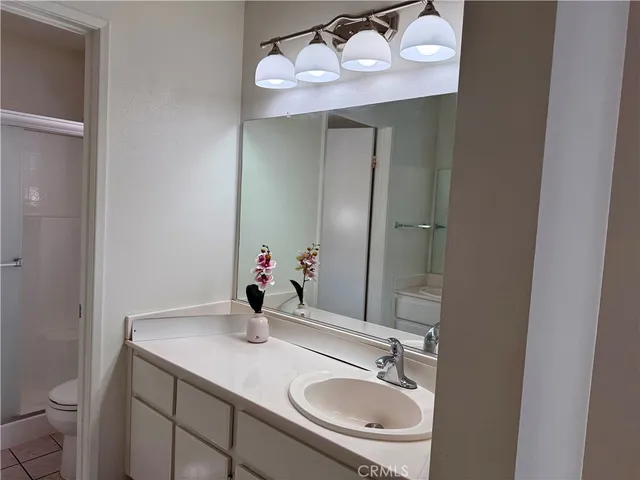 a bathroom with a sink vanity and a mirror