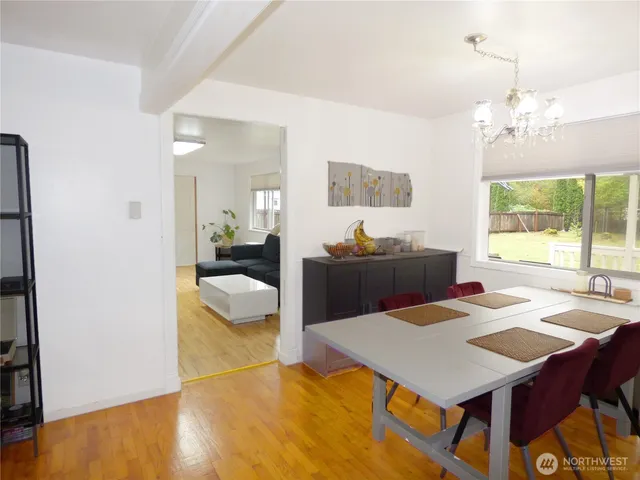 a view of a dining room with furniture and a chandelier