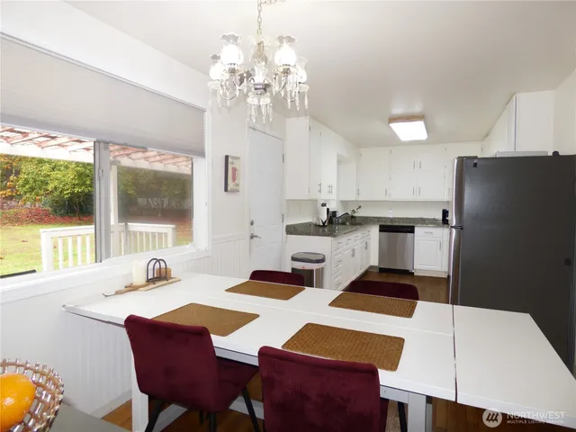 a kitchen with a table chairs stove and refrigerator