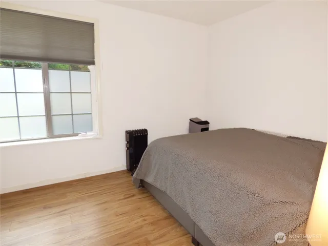 a bedroom with a bed and a window