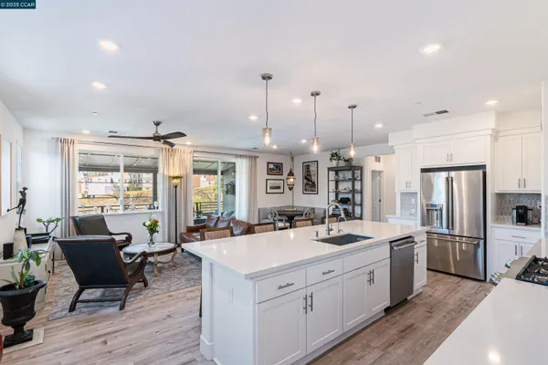 a kitchen with stainless steel appliances a sink stove and refrigerator