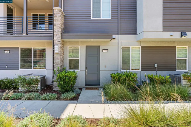 front view of a brick house with a yard