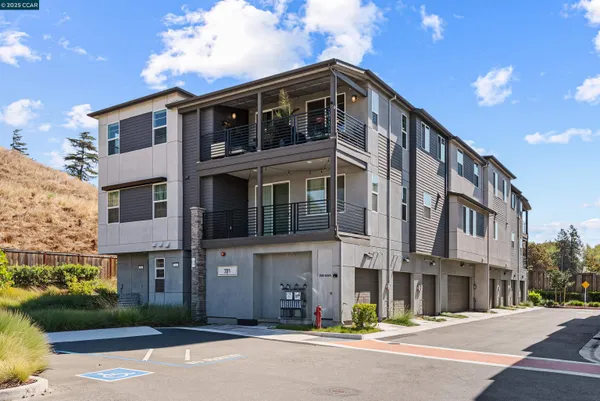 front view of a brick house with a yard